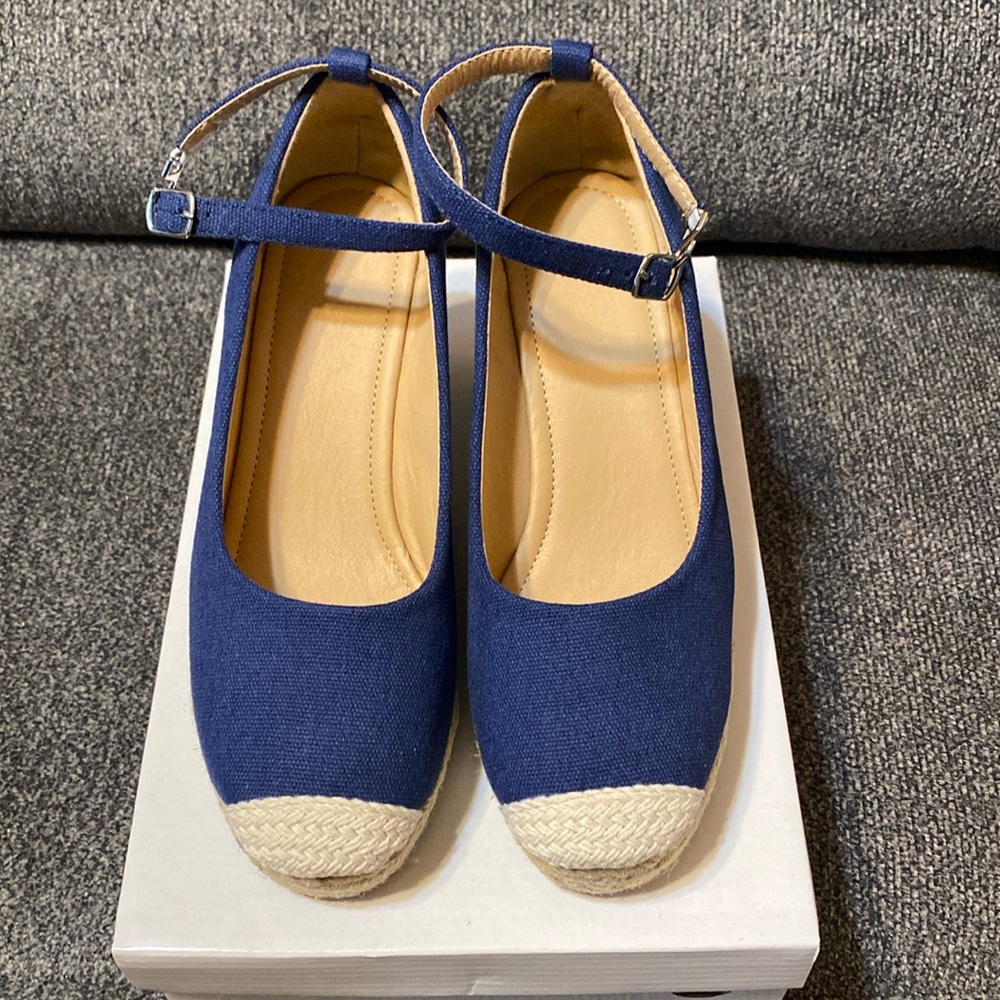 Navy  espadrilles in box with ankle strap and fastener hook.
